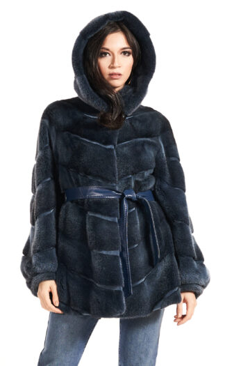 Woman's dyed blueprint sheared mink jacket with hood and blue leather inserts and blue leather sash.