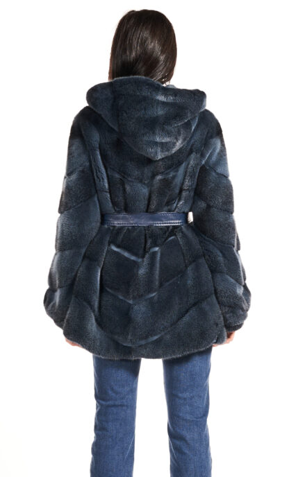 Woman's dyed blueprint sheared mink jacket with hood and blue leather inserts and blue leather sash.