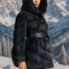 Woman's dyed blueprint sheared mink jacket with hood and blue leather inserts and blue leather sash.